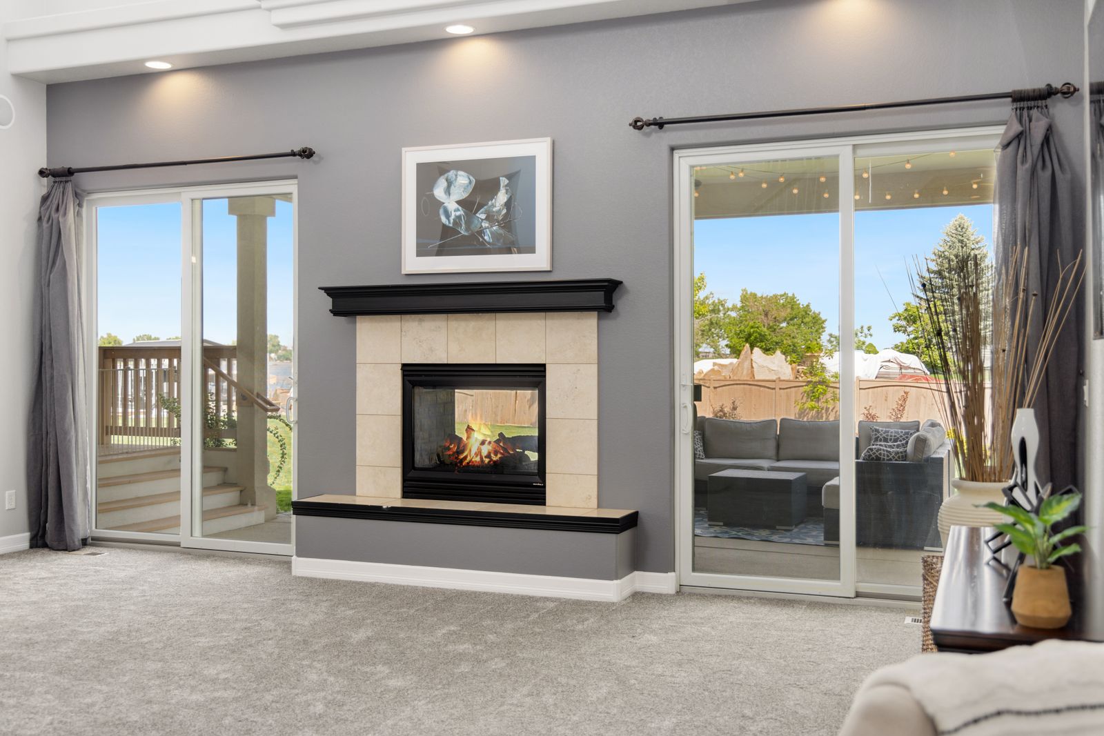 A lounge with a fireplace and glass sliding doors onto the patio.